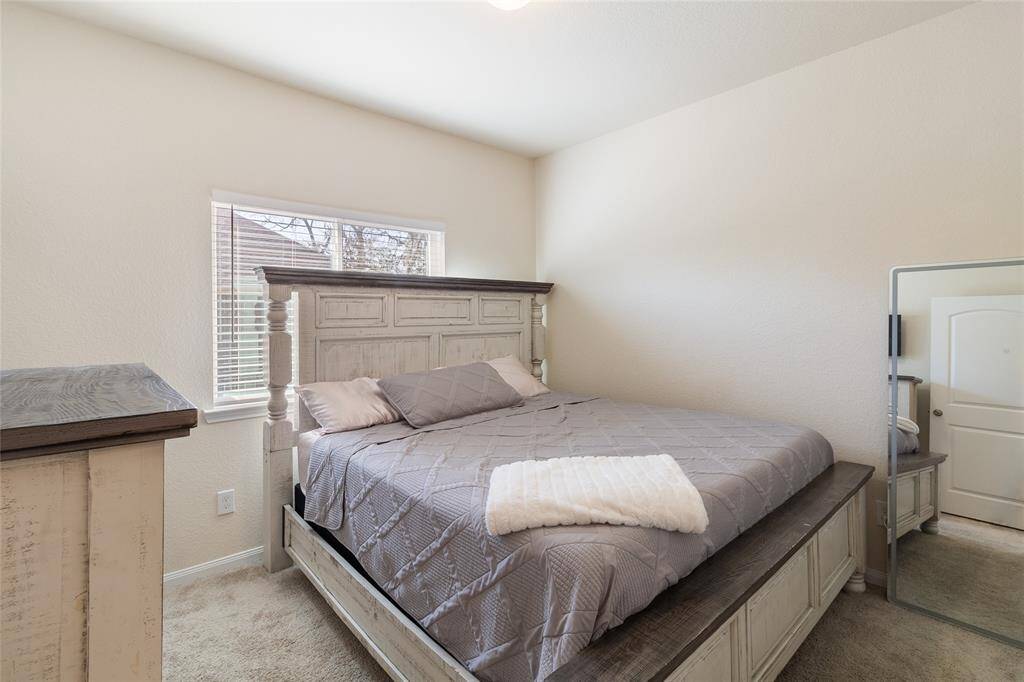 Bedroom #2 offering ample space (11x10) & a large walk-in closet. This room overlooks the extended, fenced-in side yard, providing a peaceful view & plenty of natural light.