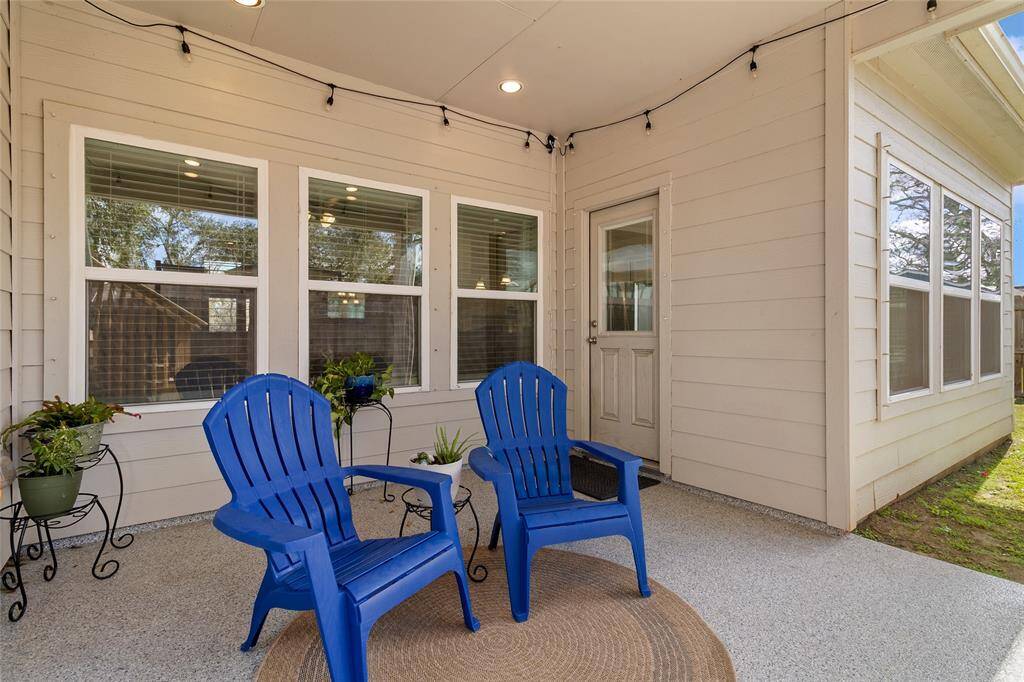 Relax & unwind on the extended covered back patio, one of two covered spaces in this backyard retreat.