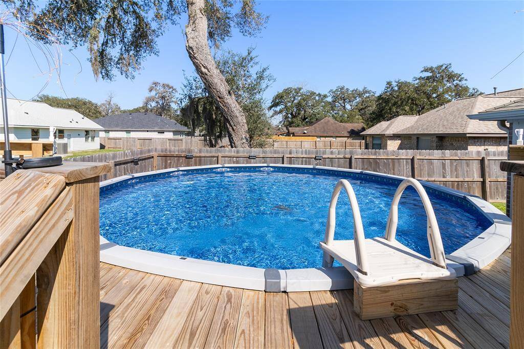 This above-ground pool is surrounded by perimeter decking, offering a perfect spot for lounging, easy access to the water & a convenient area to store towels or beverages, all while enhancing your backyard oasis.