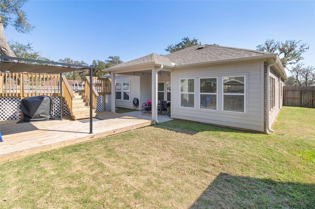 View of the backyard showcasing the expansive, extended fenced-in side yards, made possible by extending the fence to the front elevation of the home.