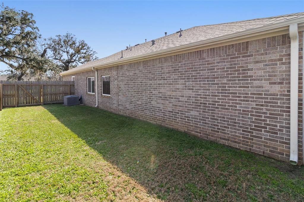 Additional extended side yard, highlighting the gutters along both sides & the rear of the home for enhanced drainage.