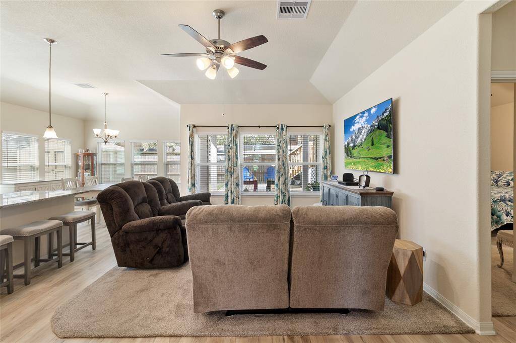 Enjoy the bright & airy atmosphere of this open-concept living space that seamlessly flows into the dining and kitchen areas, where abundant natural sunlight pours in through large windows.