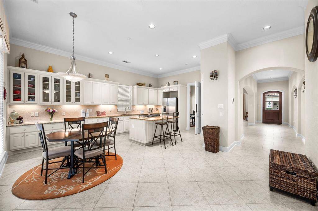 At the end of the main hall you are welcomed into the combined kitchen, breakfast, and main living spaces all open to each other offering incredible entertaining space.