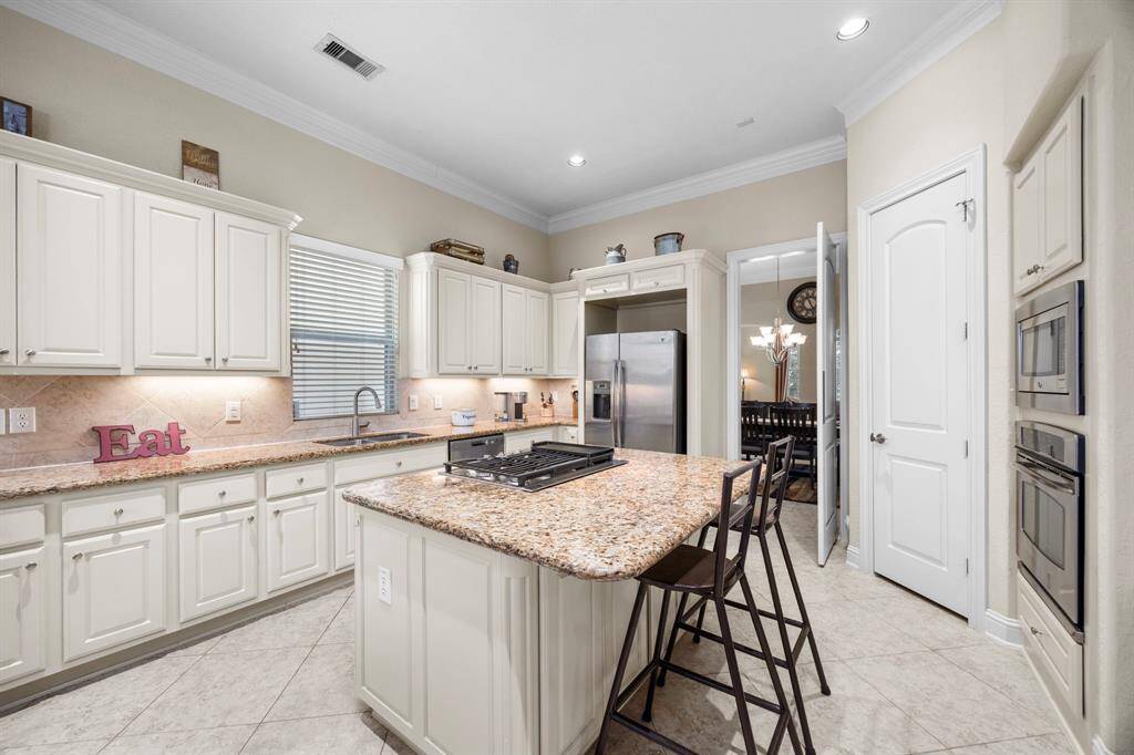 The kitchen features island seating, granite counter tops, unbelievable storage space & SS appliances including a new gas cooktop.
