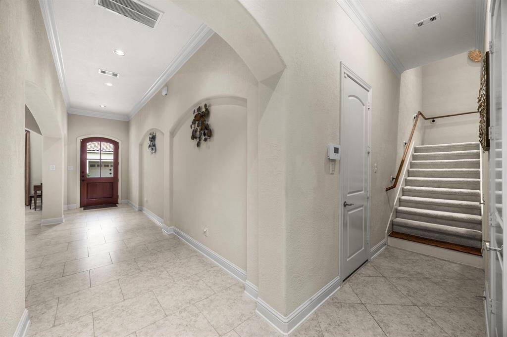 Just beyond the entry hall is access to the two car garage, wide staircase leading to the second floor, and the massive storage closet on the first floor that could be converted into an elevator shaft.