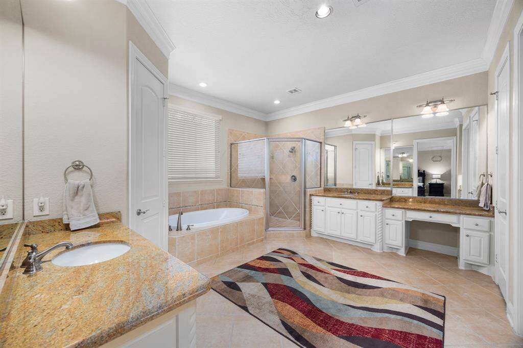 Entering the master bath you immediately notice the large scale of the room which offers separate vanities and large walk in shower