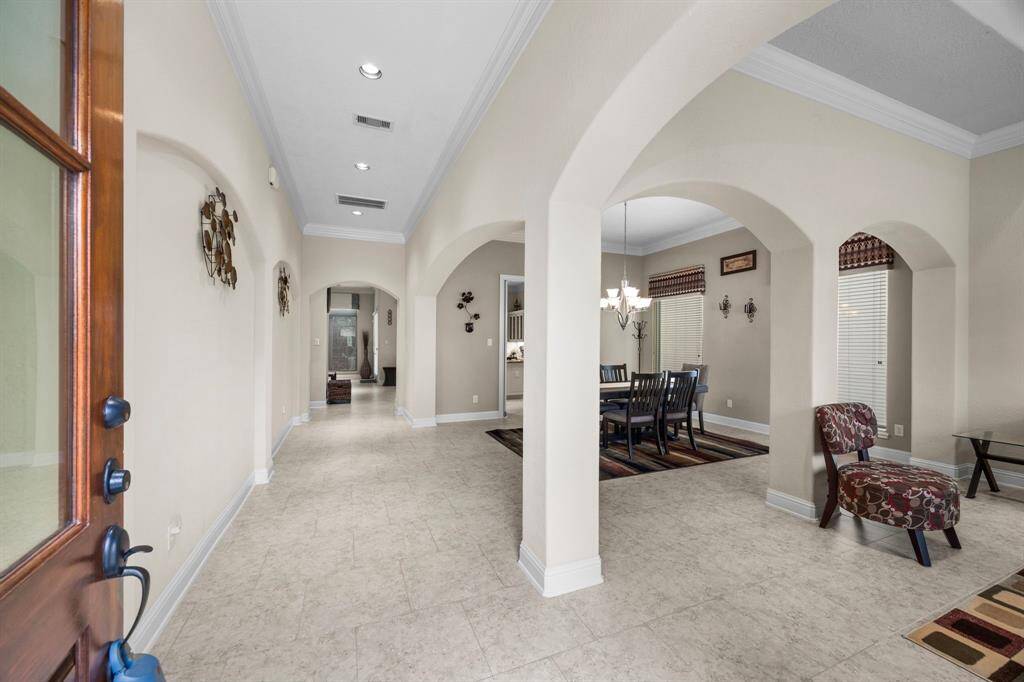 Just inside the entry you are introduced to the formal living area at the front of the home & dining just beyond. Large windows in these spaces combined with views of the main living area fill the home with natural light.