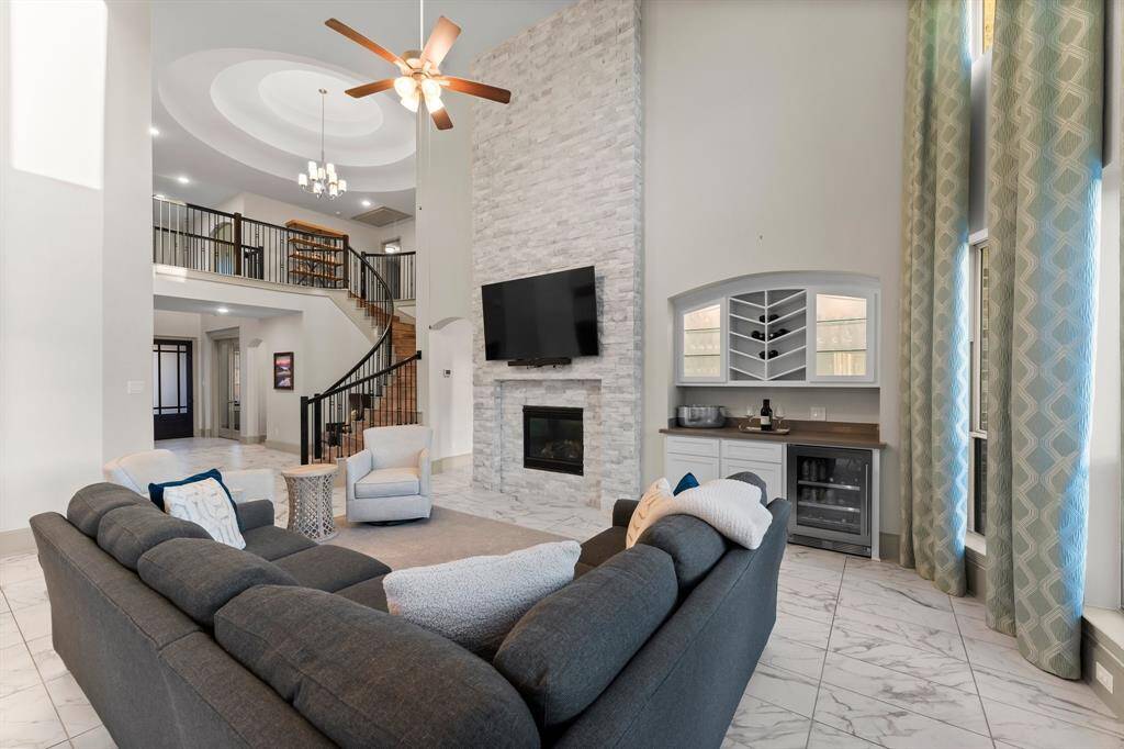 Spacious open-concept living area features high ceilings