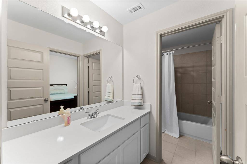 Shared bathroom with dual entry, offering convenience and privacy.