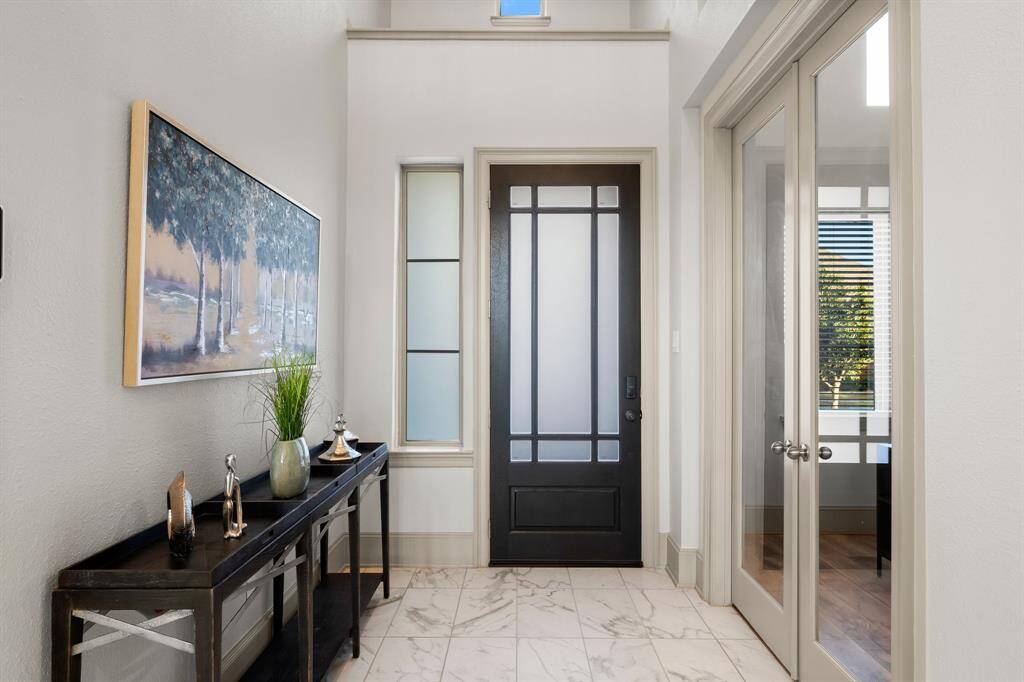 Welcome to a stunning entryway with soaring ceilings.
