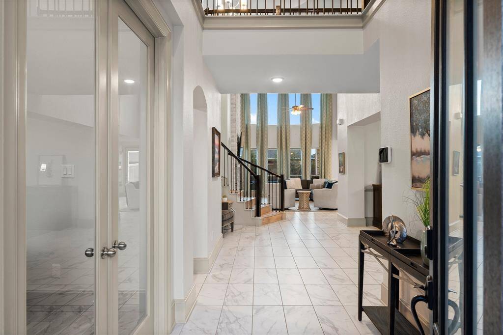 This elegant entryway features high ceilings and a spacious open floor plan.