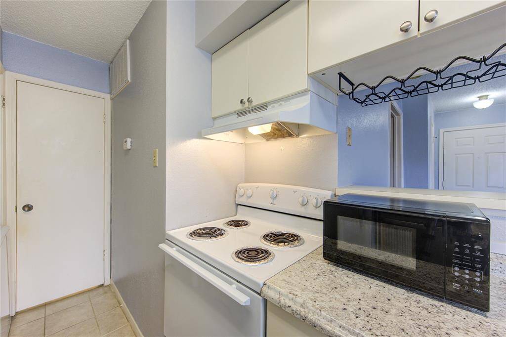 Kitchen facing the en-suite bathroom behind door