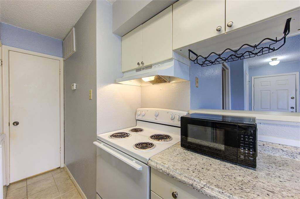Kitchen facing the en-suite bathroom behind door