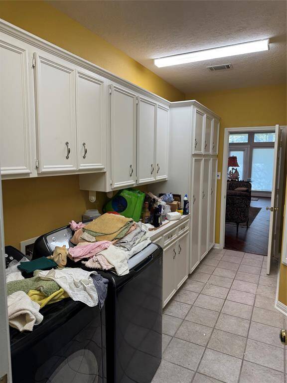Large laundry/mud room with numerous built ins. Adjoins garage entry and Primary closet for easy access.