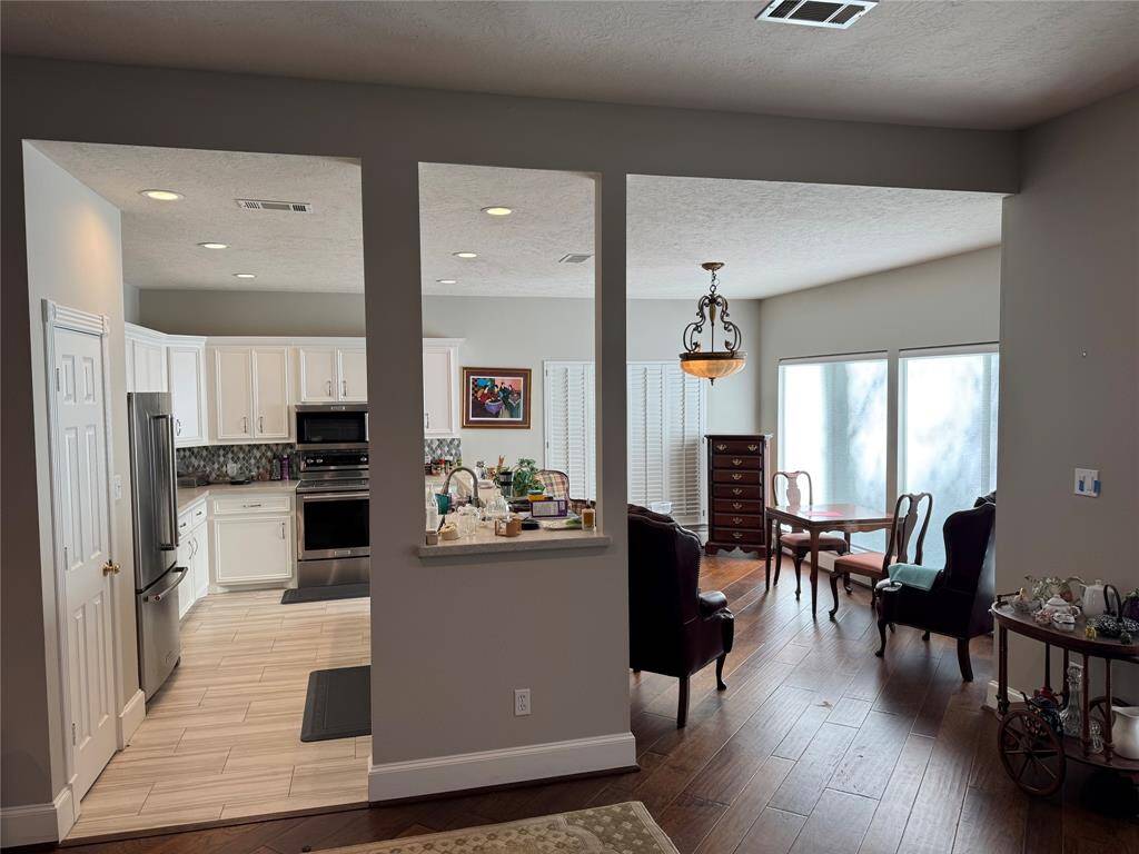 View of kitchen and dining from living room