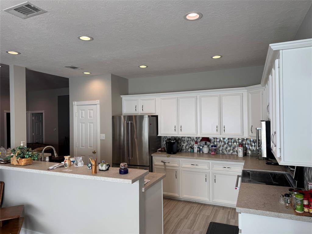 Beautifully updated kitchen with granite counters and Kitchen Aid appliances. Fridge stays with home!