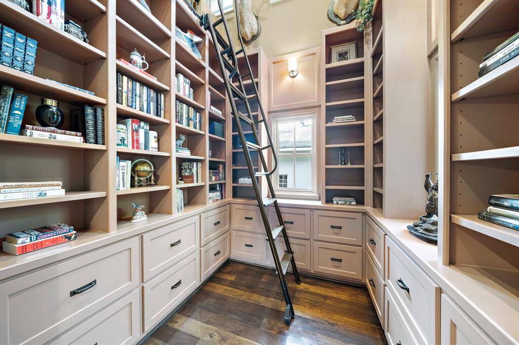 Tastefully designed, the library features a 2nd-floor loft space and an abundance of drawers, shelves, and cabinets for added convenience.