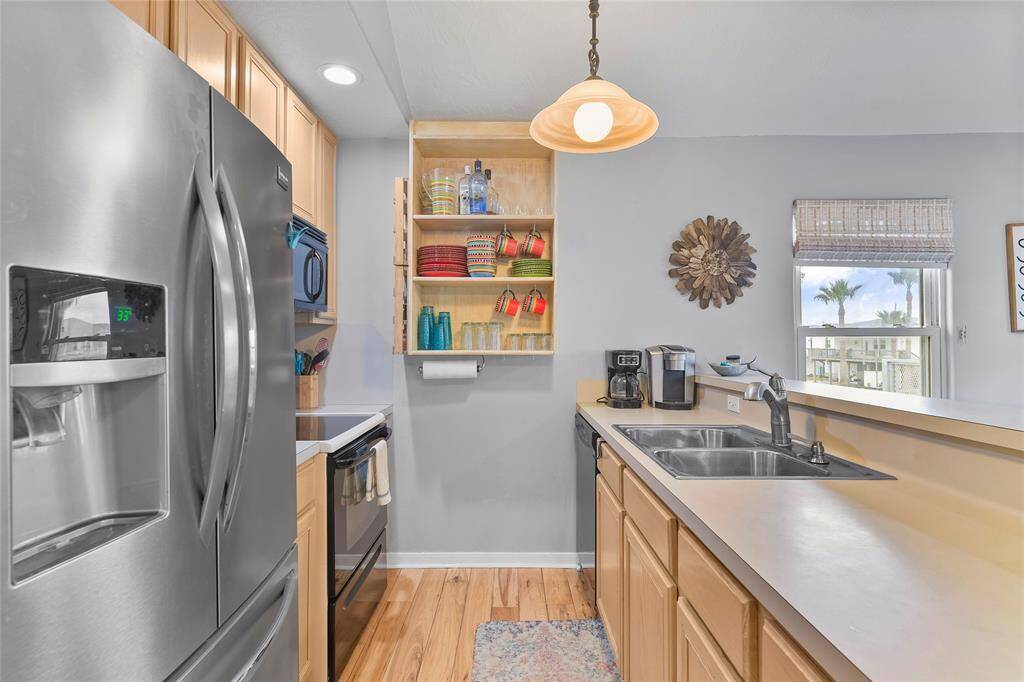 The galley style kitchen features stainless steal appliances.