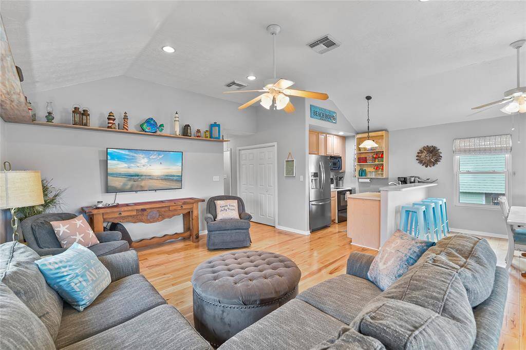 The living area is open to the kitchen, and dining area. Those ceilings!