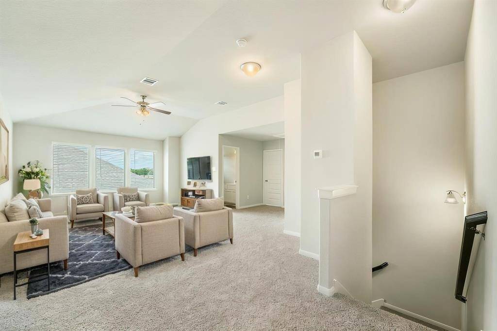 This expansive second-floor loft is perfect for a media room, home office, or play area. Featuring plush carpeting, recessed lighting, and large windows, this space provides endless possibilities for relaxation and entertainment. The attached bathroom and ample storage add to its functionality.