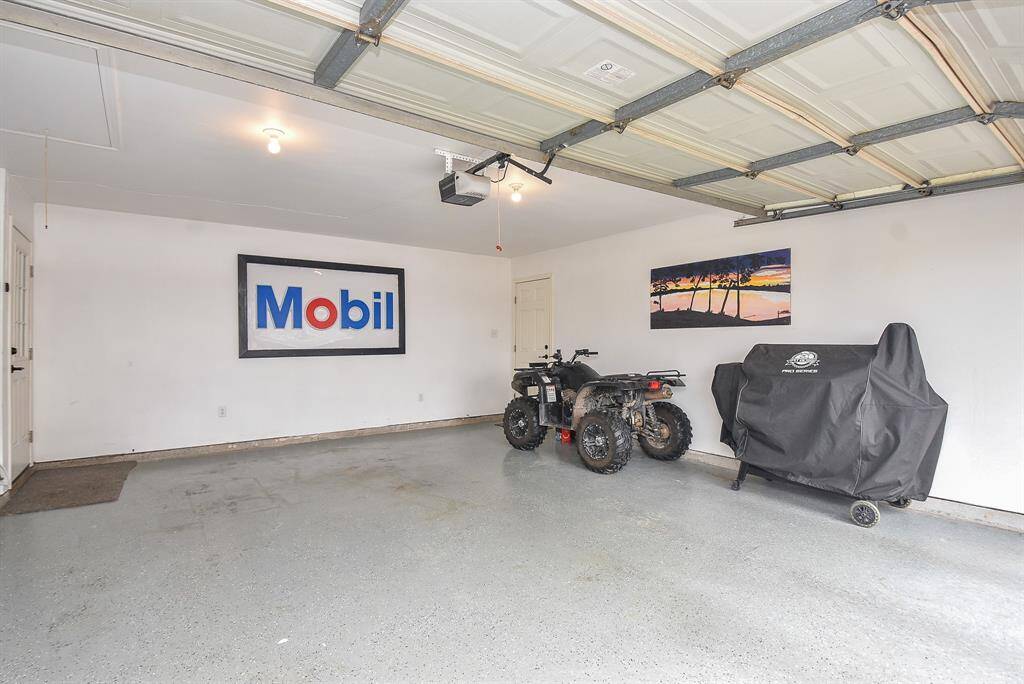 The spacious garage is spotless, inviting motorized 'toys' and/or outdoor grilling gear, as well as family vehicles.