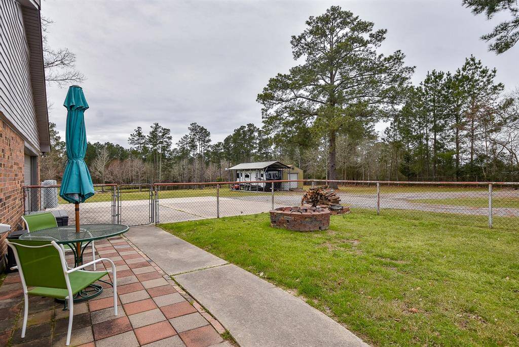 Green 'carpeting' meets pristine walkway and striking tiled patio flooring in your vast backyard.