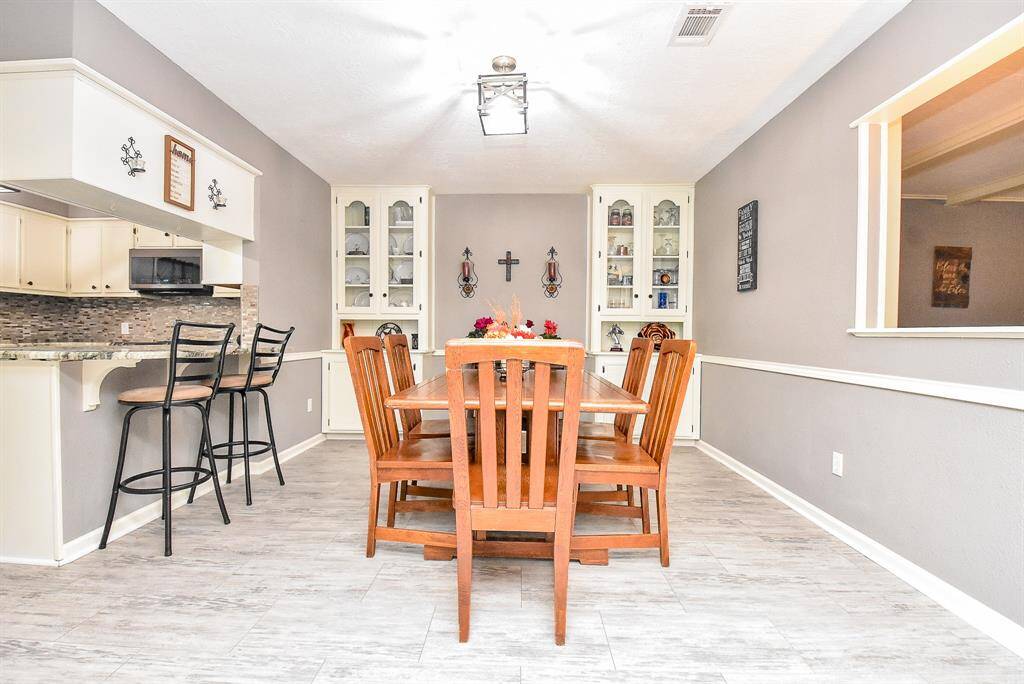 It's all in the spectacular, built-in features, and in the use of superb natural materials that warm your 'inside' lifestyle, making this home a one-of-a-kind retreat. Show here, is a formal dining area, custom built-in cabinetry, with easy access to kitchen and extended counter, left.