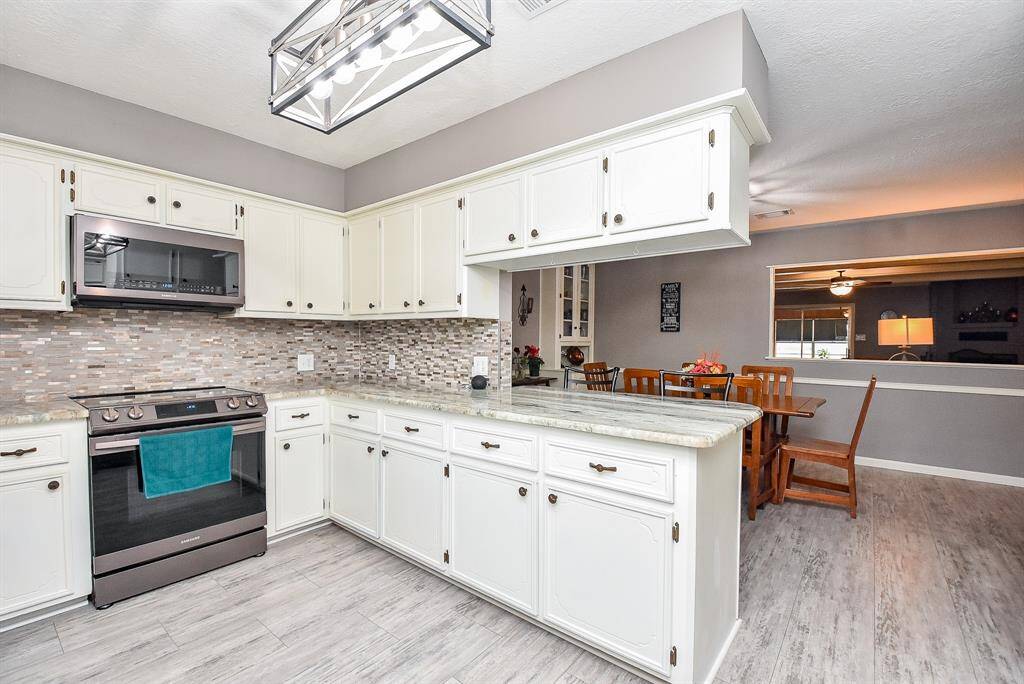 What a marvelously warm, relaxing look from kitchen/dining areas into your living area, right, through a sleek wall cut-out.