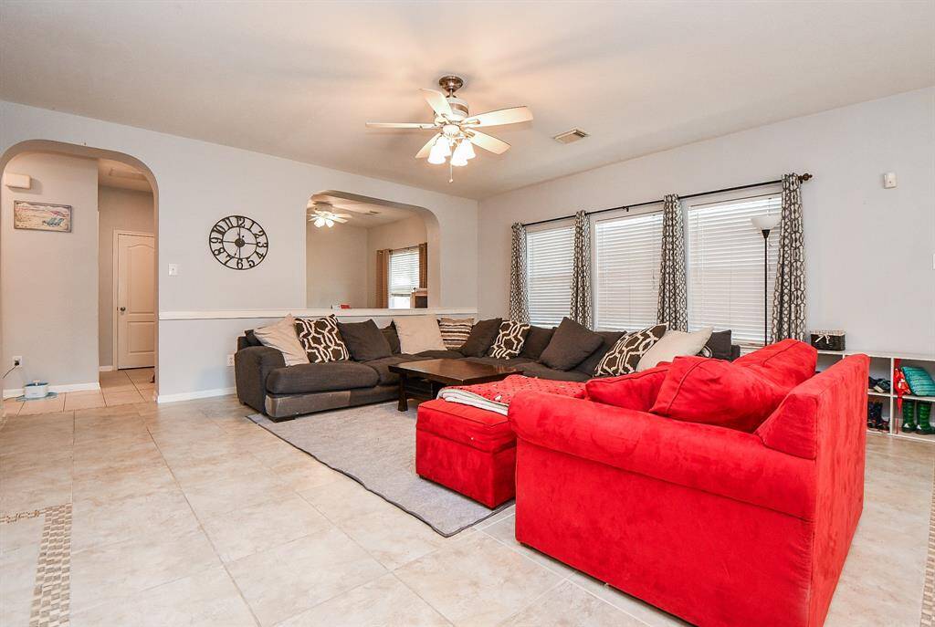Walls of windows bring pure natural light into this living/combined space, with high ceiling above, gorgeous custom detailed tile flooring and room, galore!