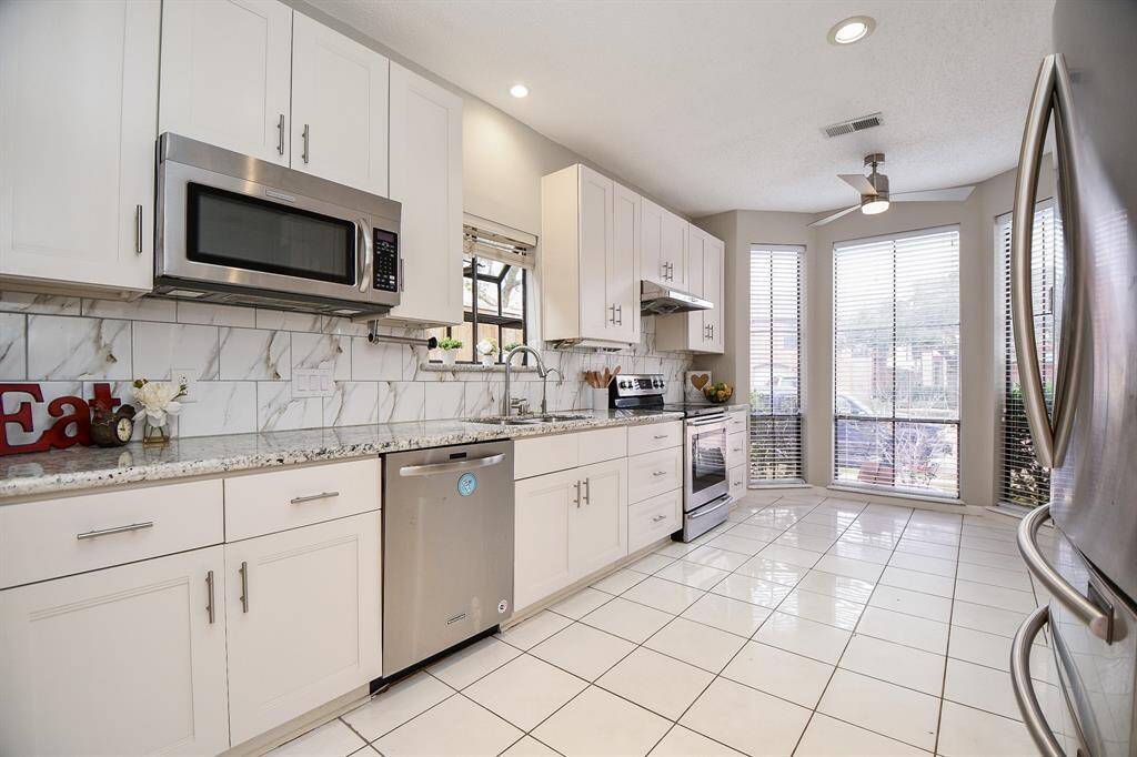 Kitchen with tile floor.  Refrigerator included.