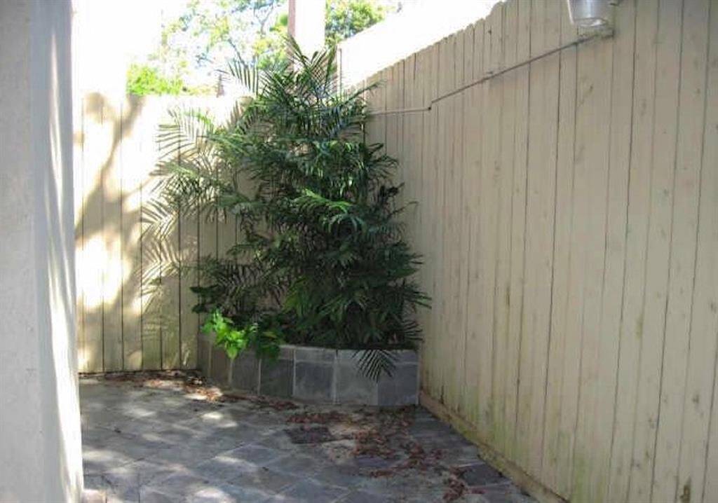 The patio has built in planters at either end of the slate covered patio.
