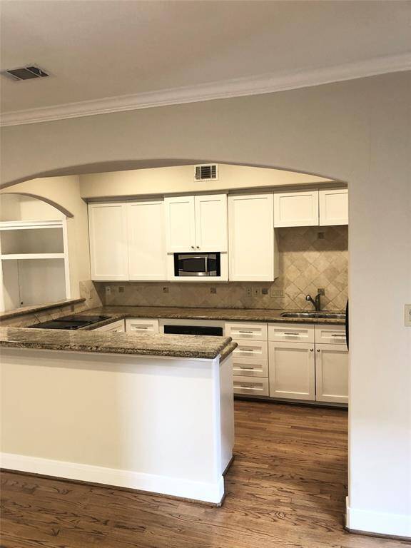 This classic white kitchen is open to the living and dining areas. 1st floor living!