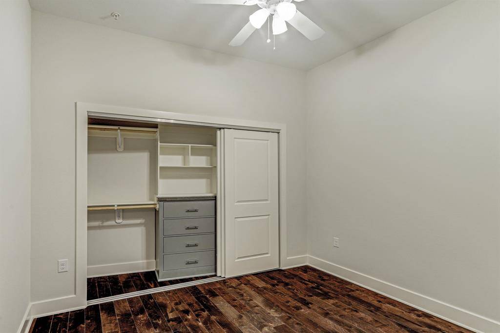 Primary Bedroom with elegant hardwoods, and a large closet with telescoping sliding doors and built-in cabinets and shelving.  Ready to be furnished to your exclusive taste