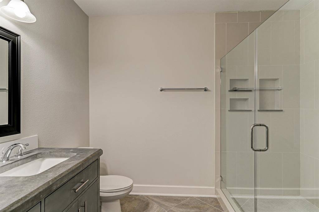 Spacious Primary bath with chic vanity and oversized frameless shower