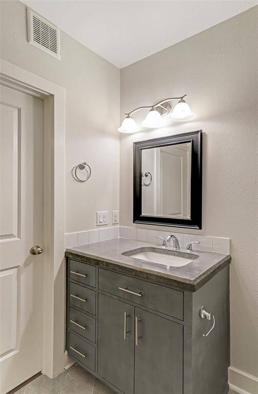 Vanity has polished countertops and great storage
