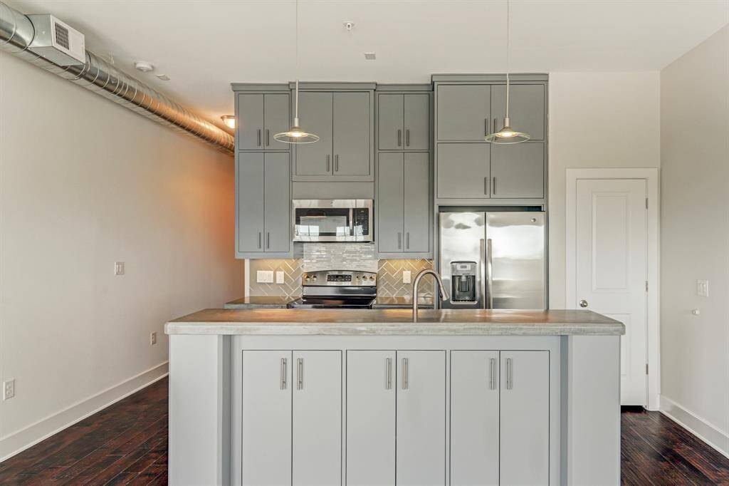 Unit features bespoke pendant lighting and designer paint colors