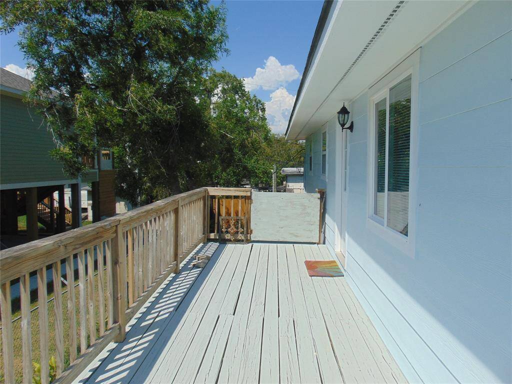 Side of balcony by front door.