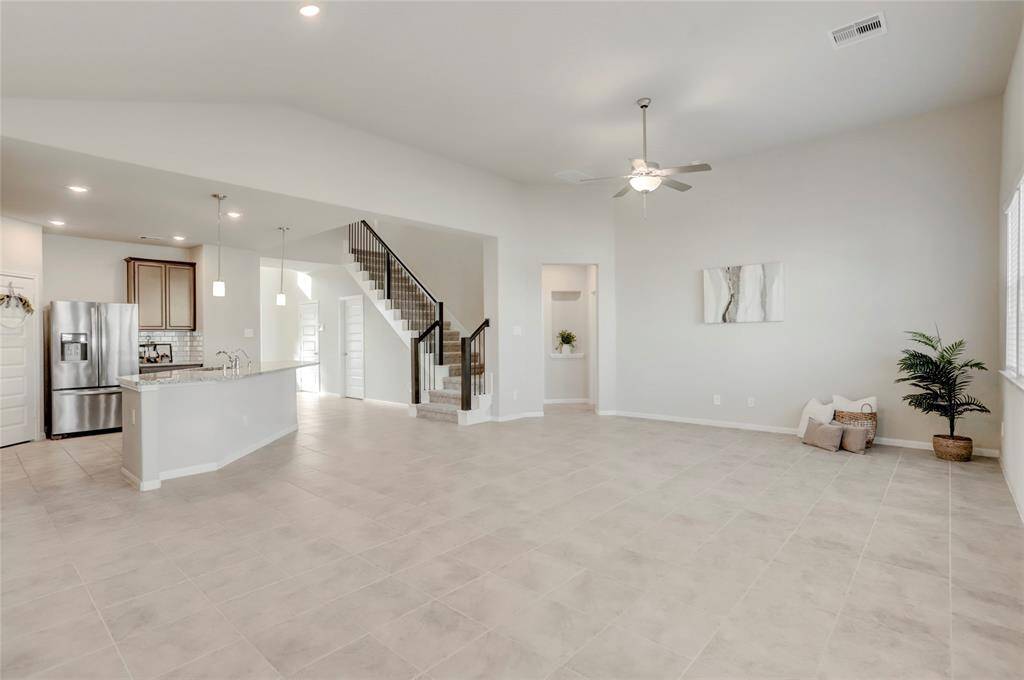 A bright and inviting family room seamlessly opens to the dining/breakfast area, creating a perfect space for gathering and entertaining.