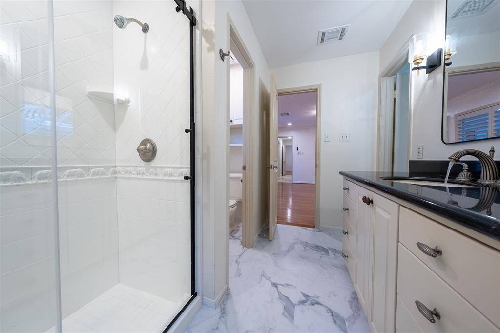 Step into primary suite, where ample store meets an elegant en-suite bath adorned with detailed decors.