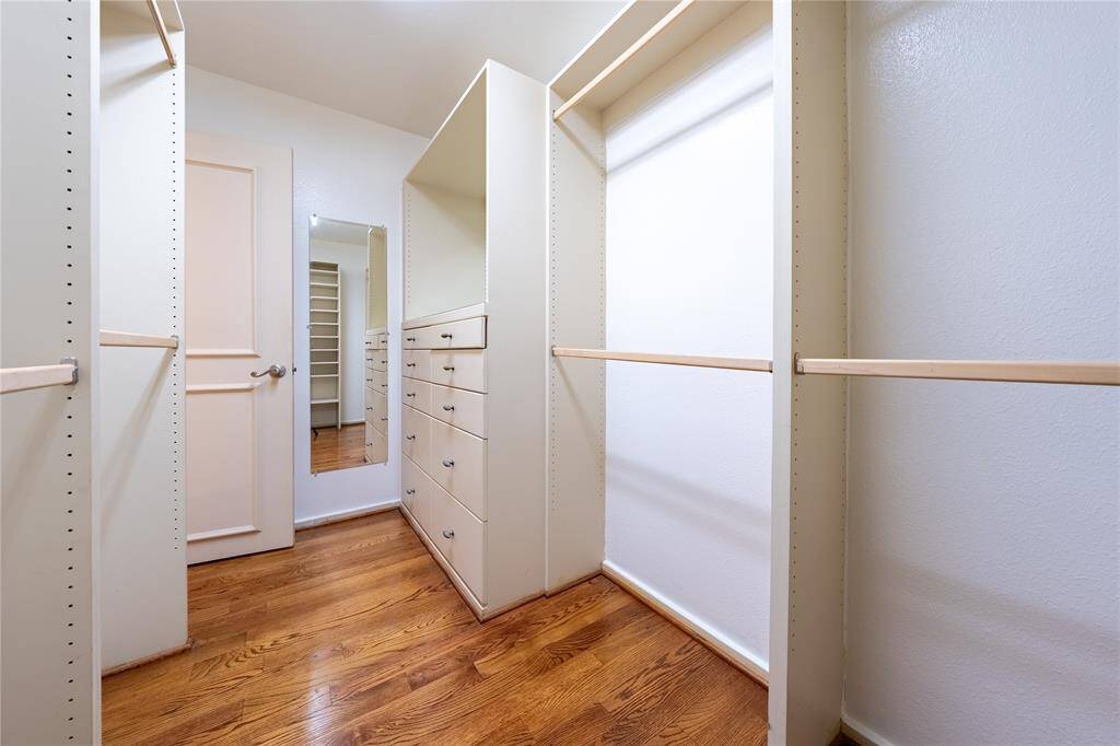 This thoughtfully designed primary walk-in-closet with built-in drawers to ensure you have all the space you need to stay organized and relaxed.