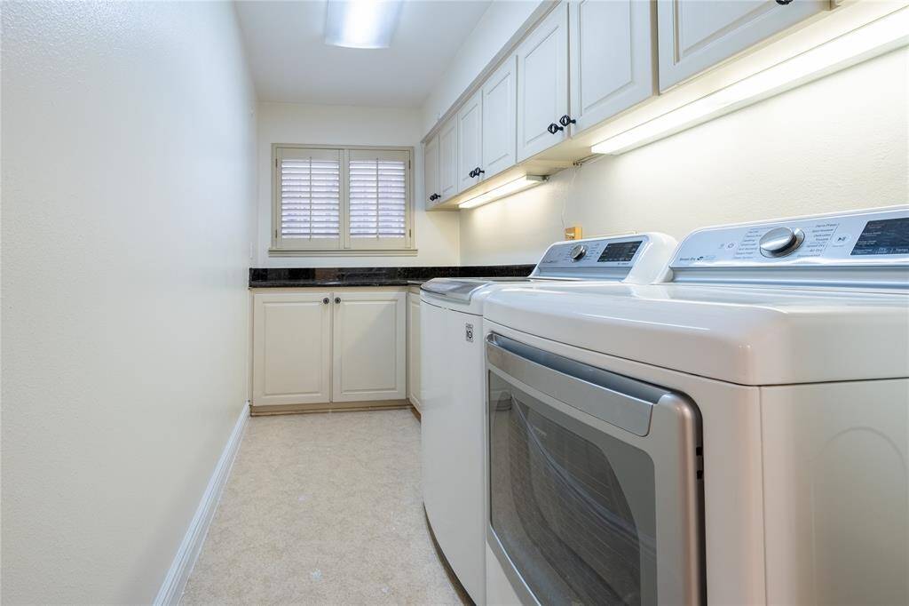 Imagine your laundry routines in this meticulously designed space with granite countertop, providing ample surface area for all your laundry needs. The abundance of cabinets ensure you have plenty of storage to keep everything organized and within easy reach.
