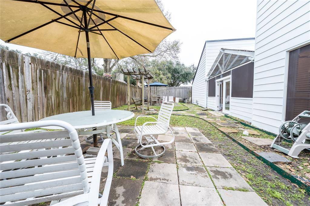 This inviting backyard space boasts ample room for all your outdoor seating needs, making it the perfect setting for relaxed gatherings, leisurely afternoons, or serene moments of solitude.