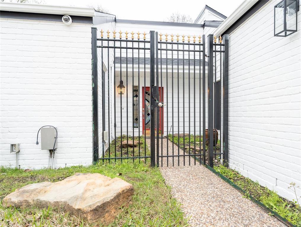 Notice the charming rod iron gate entrance that adds a touch of elegance and security.