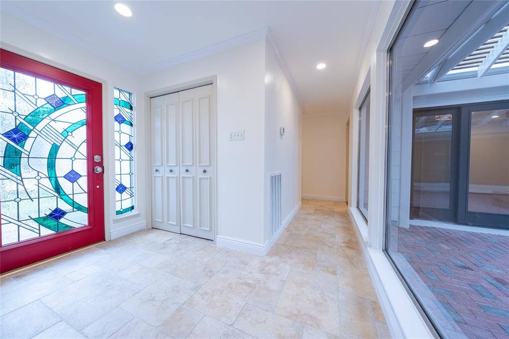 Step into a grand entrance that immediately captures your attention with its stunning tile floors, which gracefully extend throughout the entire living area.