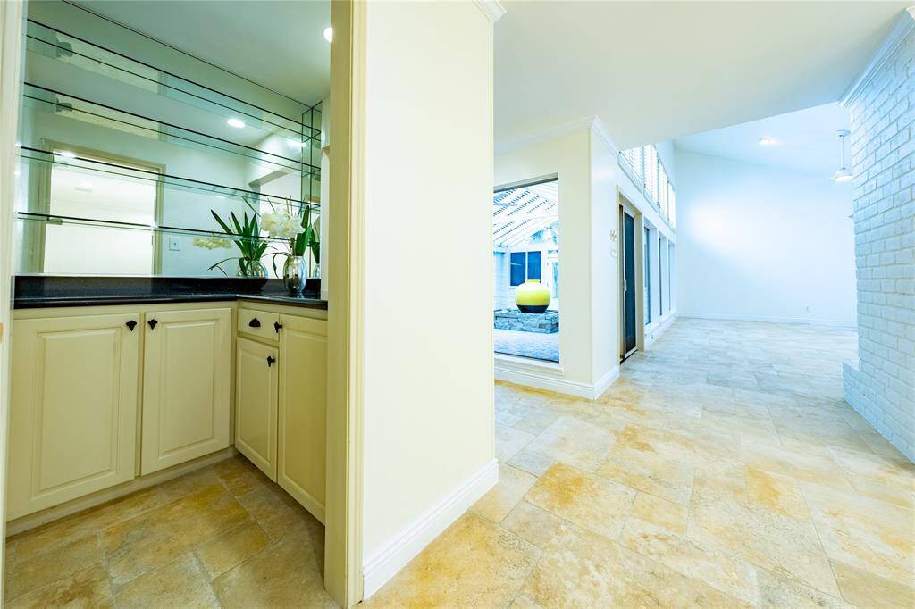 Indulge in the perfect blend of sophistication and convenience with a centrally located wet bar, an absolute delight for wine or cocktail enthusiasts. This stylish feature ensures that your favorite vintages are always within reach.