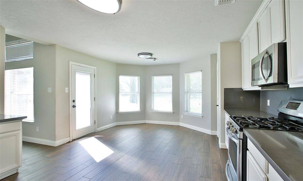 View of the Breakfast Room in the Kitchen Area.  The door on the left allows access to the patio and backyard.