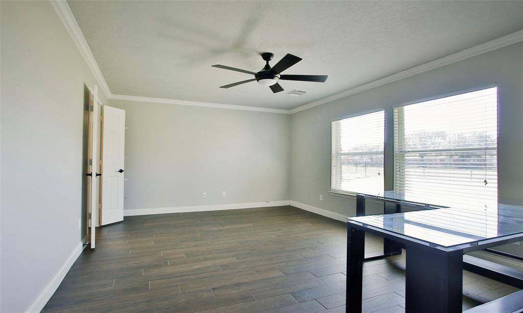 The light and bright Primary Suite overlooks the backyard with views of the lake!