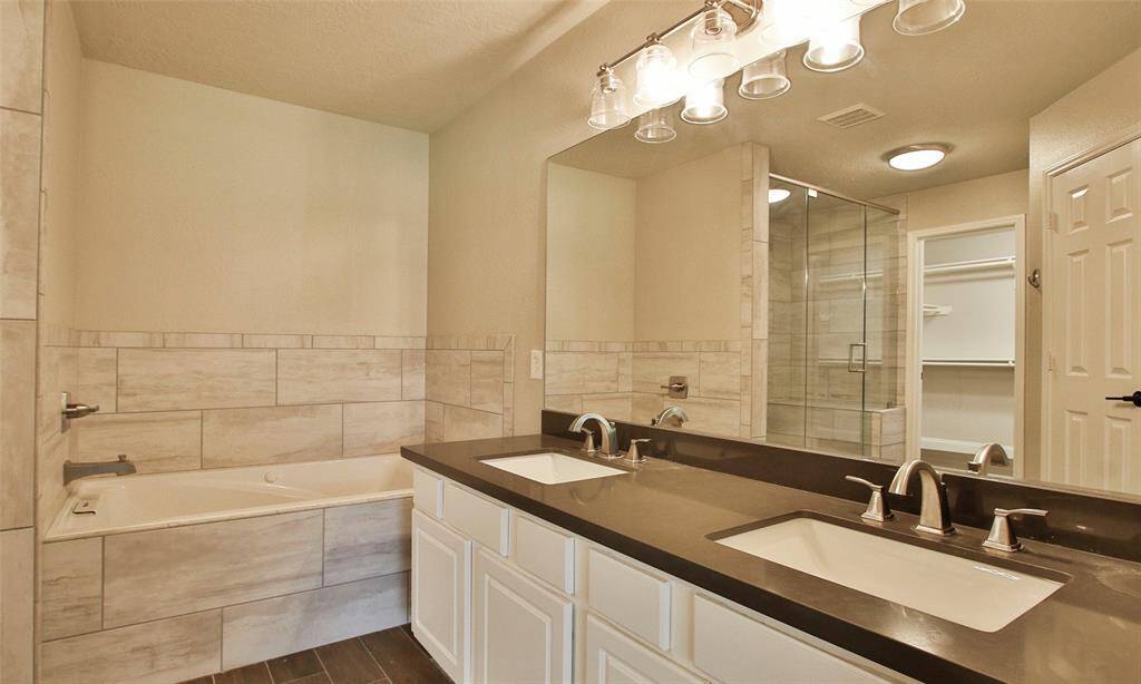 The Primary Suite features double sinks, soaking tub, and seperate shower.
