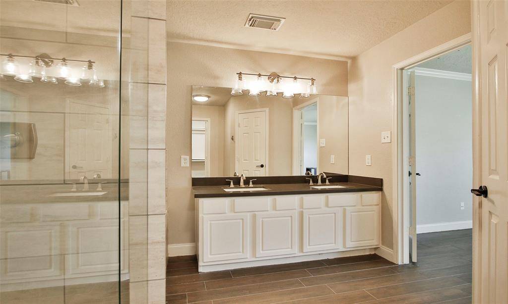 Primary Bath features double sinks with quartz countertops.