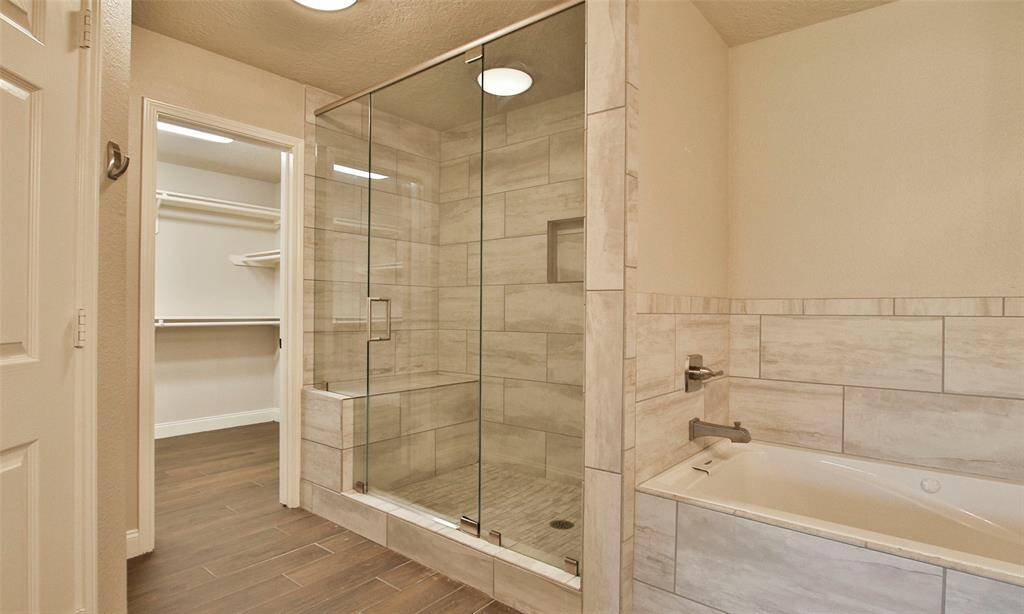 Primary Bath with full glass shower and bench.